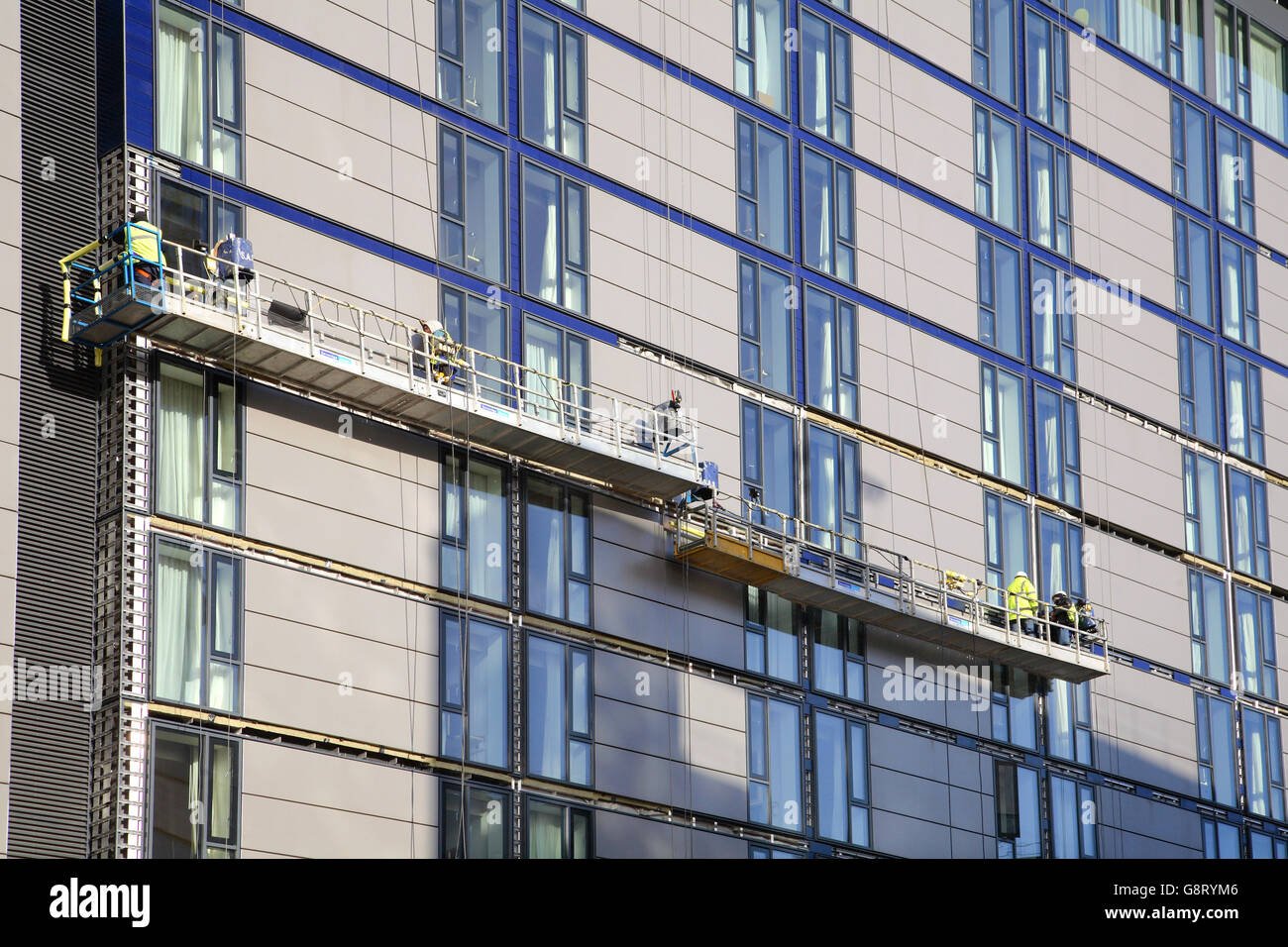 construction workers use suspended access platforms to install ceramic g8rym6